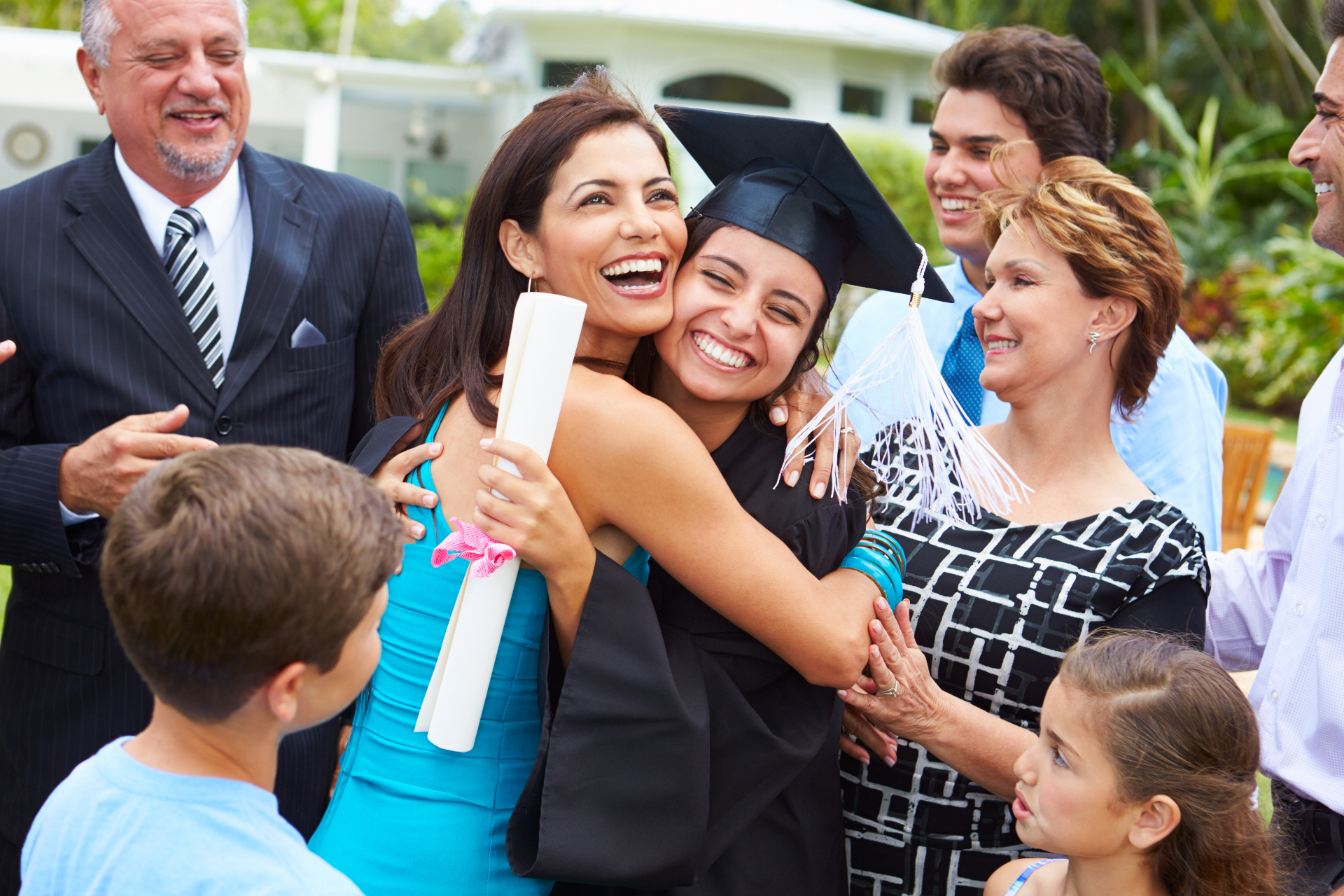 A high school graduate celebrating with her family after college counseling helped her find the right college fit